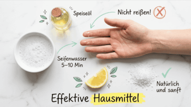 Hand mit Sekundenkleber-Resten an den Fingern auf hellem Marmor, daneben Schale mit Seifenwasser, Speiseöl, Zitrone und Speisesalz als Hausmittel